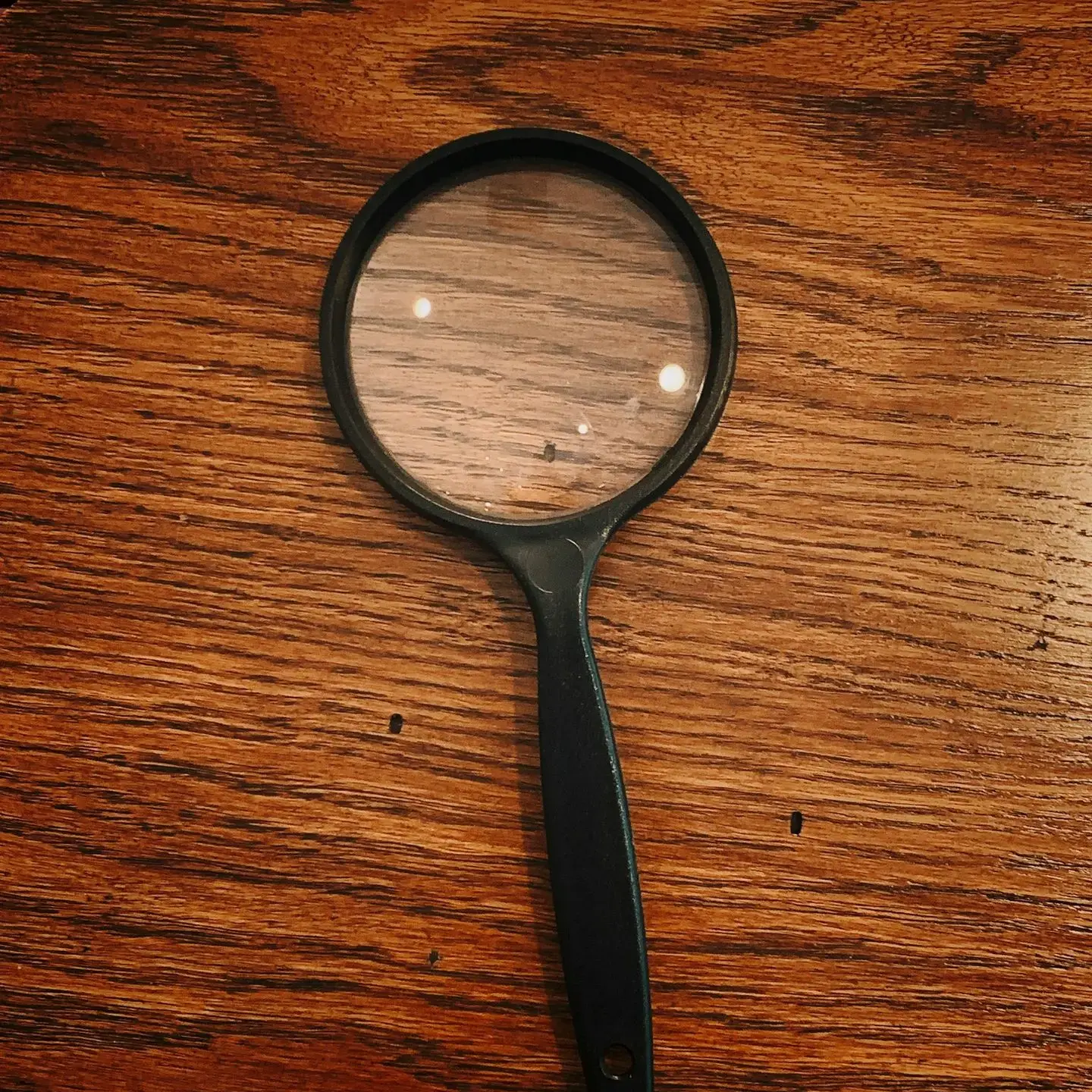 black framed magnifying glass